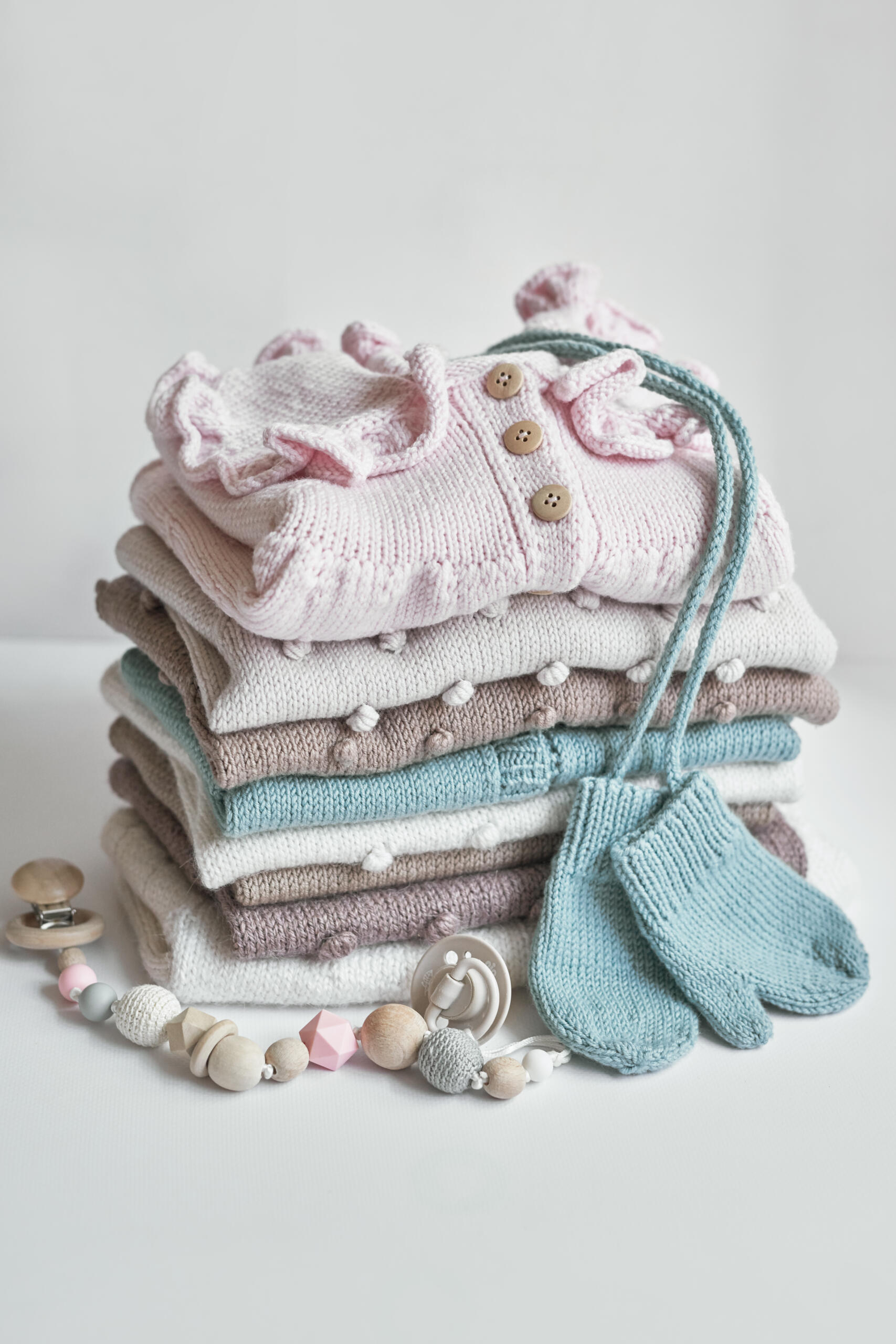 Children's knitwear. Jumper, hat, socks. Baby shower party. Baby knit clothes.